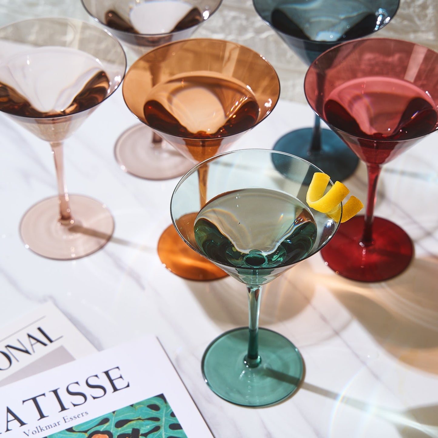 Colorful cocktail glasses with drinks on a newspaper